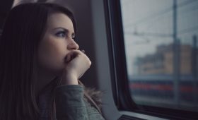 teen looking wistfully out a window