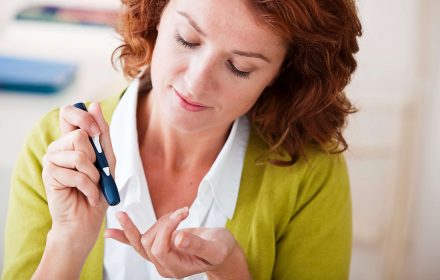 diabetes blood test, woman pricks finger