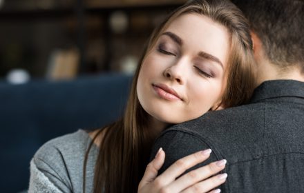 Better relationships, woman hugging man, peaceful face